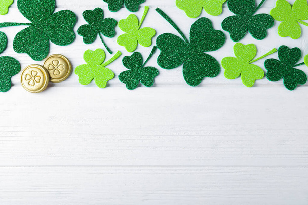 Flat lay composition with clover leaves on white wooden table, space for text. St. Patrick's Day celebration - Fotoğraf, Görsel