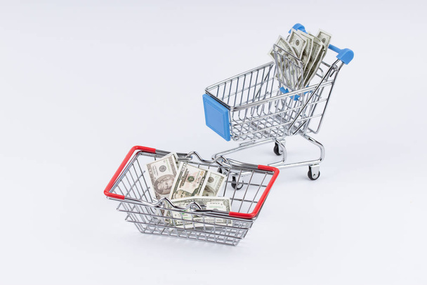 Shopping cart with moneys on white background - 写真・画像