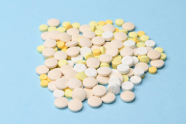 yellow and white tablets on a blue background close up - Photo, Image