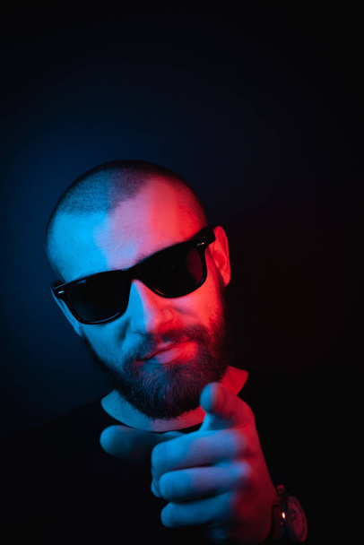 Brutal portrait neon style. Portrait of the face of a charismatic guy with a beard. - Photo, Image
