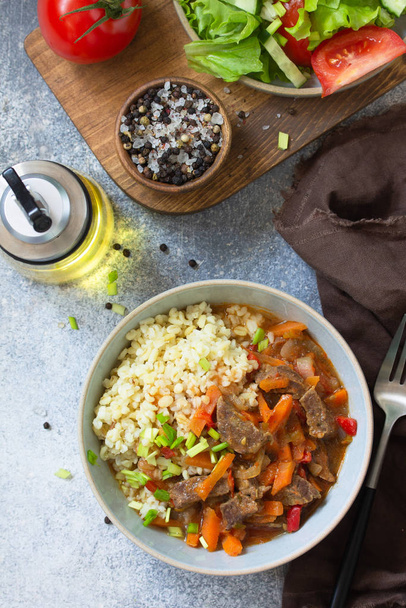 Healthy eating concept. Beef stewed with vegetables in bulgur sa - Photo, Image