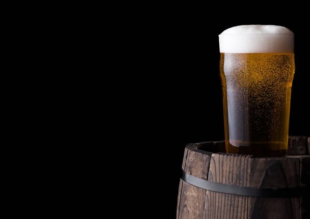 Cold glass of craft beer on old wooden barrel - Fotografie, Obrázek