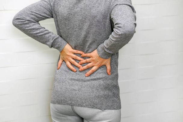 Woman, pain at lower back. Health care concept. - Photo, Image