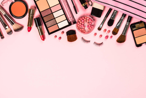Makeup professional cosmetics on pink background. - Фото, изображение