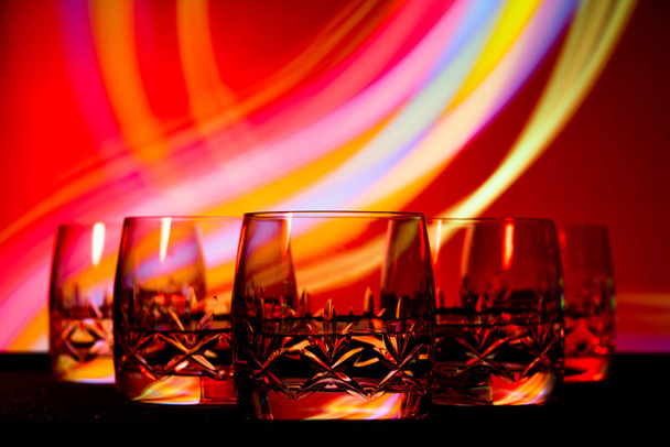 glasses in the multicolored light of the club. - Valokuva, kuva