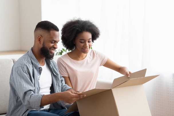 Happy afro man en vrouw klant unbox pakket bestelling - Foto, afbeelding