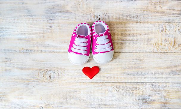 Baby booties and heart on a light background. Selective focus. - Photo, Image