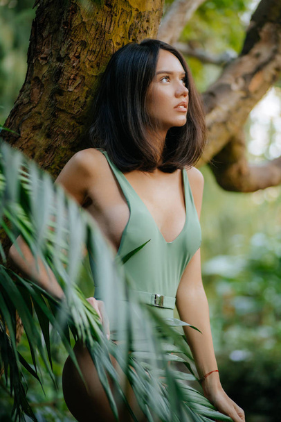 sensual young brunette lovely woman in tropical jungle - Fotó, kép