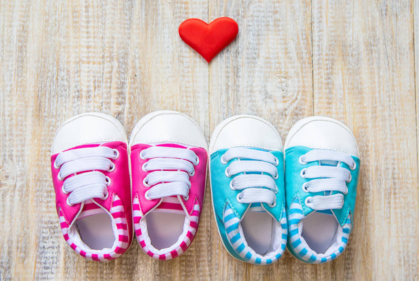 Baby booties and heart on a light background. Selective focus. - 写真・画像
