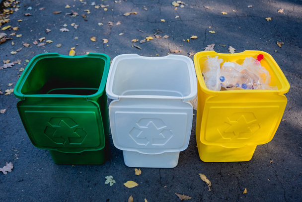 Three trash containers in different color, for sorted waste. - Foto, immagini