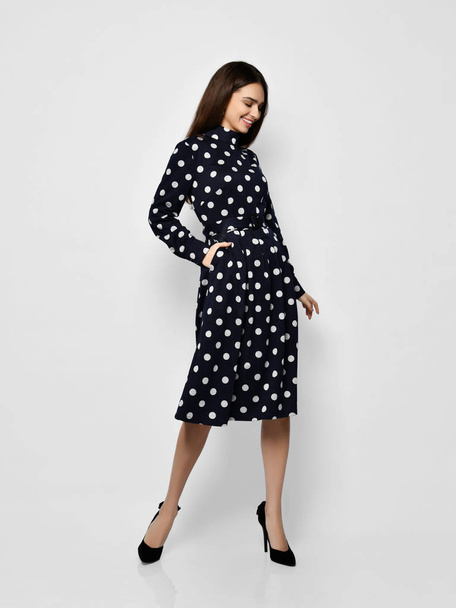Young beautiful woman posing in new casual fashion spring blue polka dot dress full body - Photo, Image