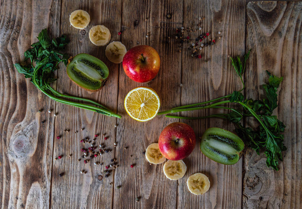 fruits and herbs on a wooden table surface - Foto, imagen