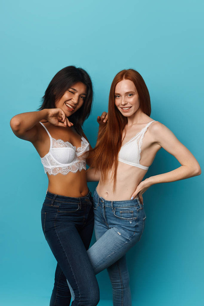 funny cool girl in fashion jeans and lingeries posing to the camera - Zdjęcie, obraz