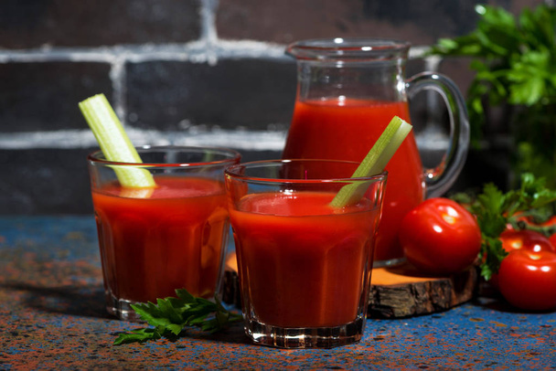 fresh tomato juice with celery in glasses on table - Foto, Imagem