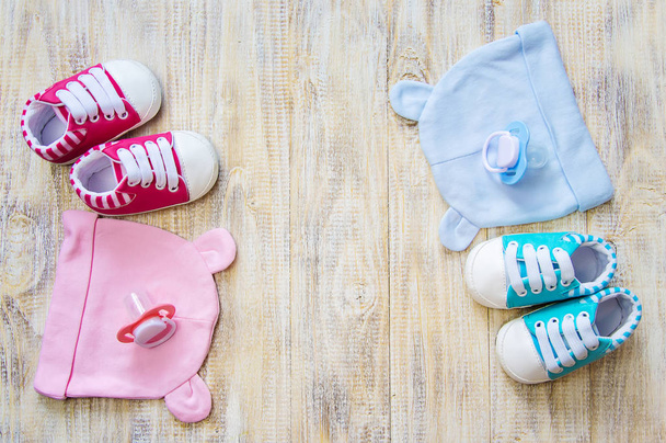 Baby clothes and accessories on a light background. Selective focus. - 写真・画像