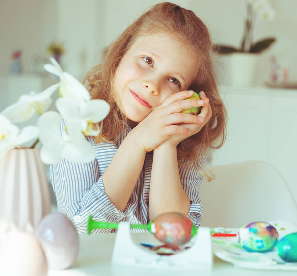 Cute little blonde girl painting Easter eggs - Photo, Image