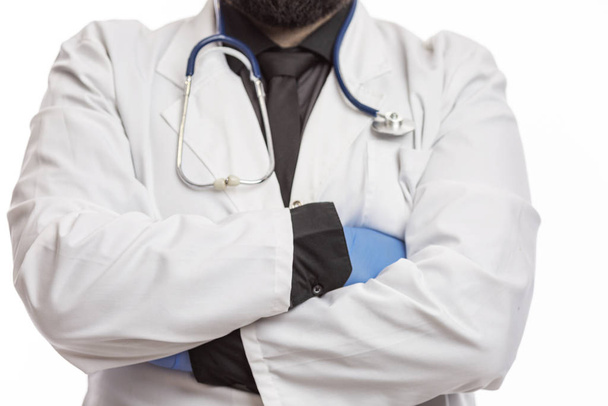 Male doctor in a white coat with a stethoscope and gloves. White background. - Photo, image