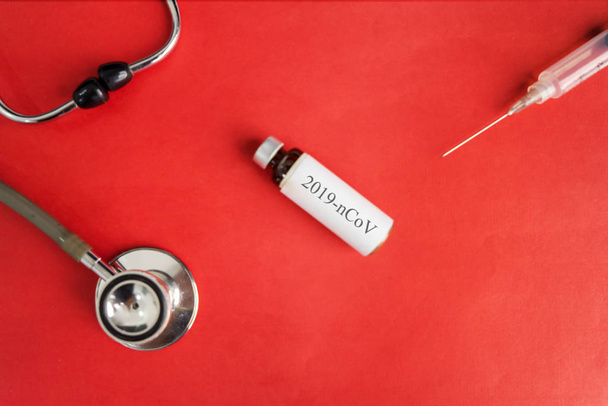 nCoV vaccine bottle with stethoscope and syringe - Φωτογραφία, εικόνα