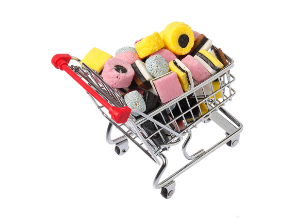 Shopping cart filled with assorted English liquorice candy - Photo, Image