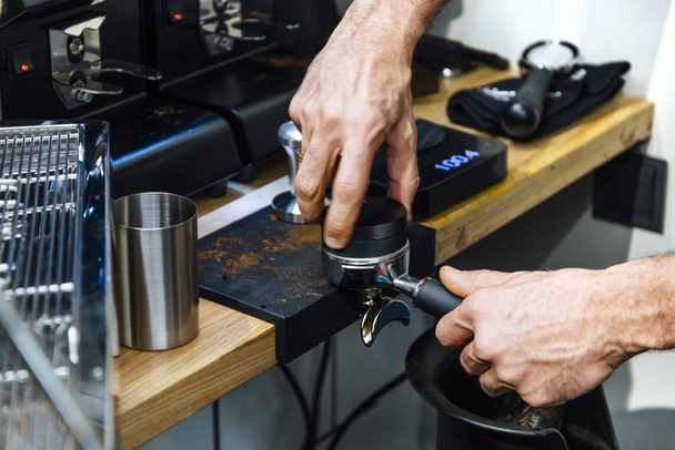 Barista pressing coffee to portafilter - Photo, Image