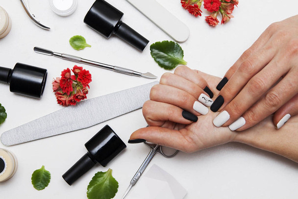 Matte black and white manicure on woman's hands. Tools for manic - Fotoğraf, Görsel
