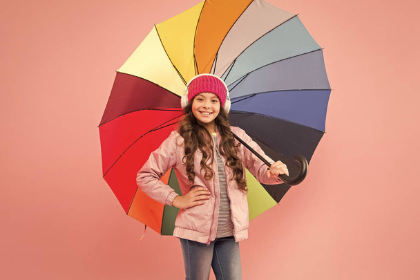Accessory in case it rains. Small child enjoy music under colorful umbrella rain accessory. Little girl in coat with fashion accessory for rainy autumn season. The perfect accessory to keep her dry - Photo, image