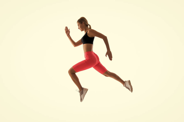 Dynamic movement. Woman runner isolated on white. Jogger running. Sporty runner in fashionable sportswear. Fitness and sport motivation. Strong and fit. Athletic woman sprinter or runner. Best runner - Foto, Imagem