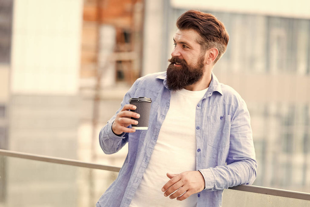 Coffee completes me. Make yourself useful. Man drink take away coffee. Bearded man relax outdoors. Coffee break concept. Caffeine addicted. Morning coffee. Mature hipster enjoy hot beverage - Photo, image