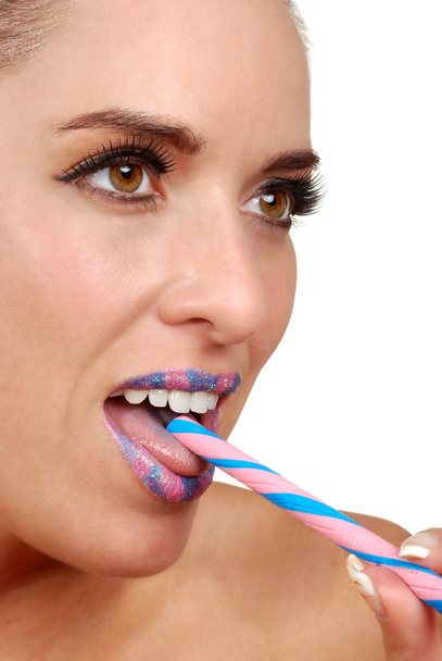 Woman with pink and blue candy stick - Фото, изображение