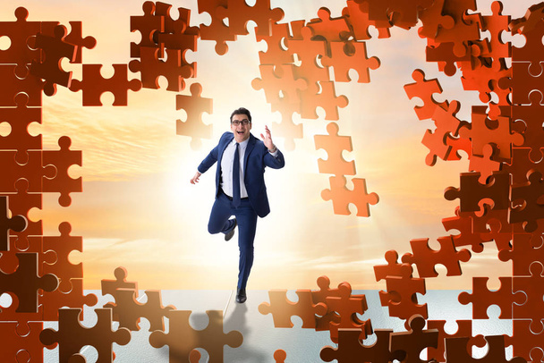 Businessman breaking the wall of jigsaw puzzle - Photo, Image