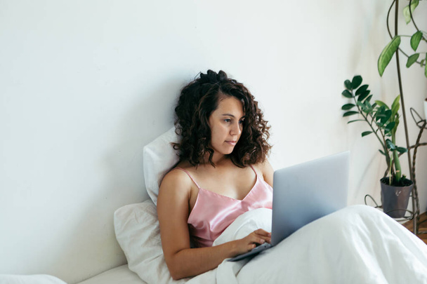 woman with laptop in bed freelancer - Photo, Image