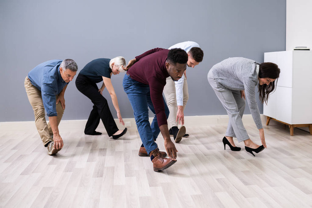 Group Of Happy Young Businesspeople Doing Stretching Exercise In Office - Fotoğraf, Görsel