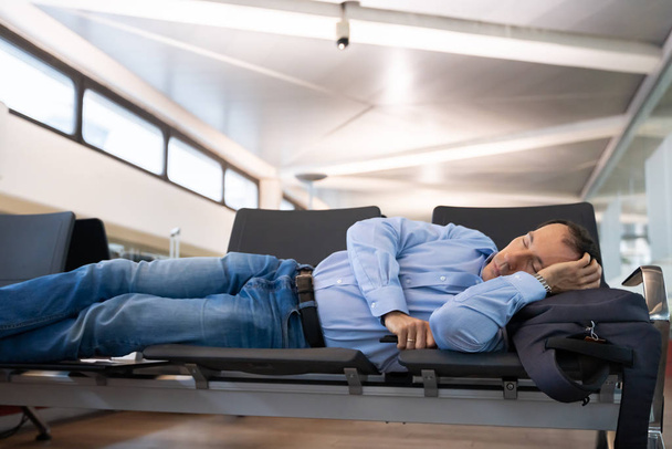 Delayed Flight. Man Sleeping In Airport Terminal - 写真・画像