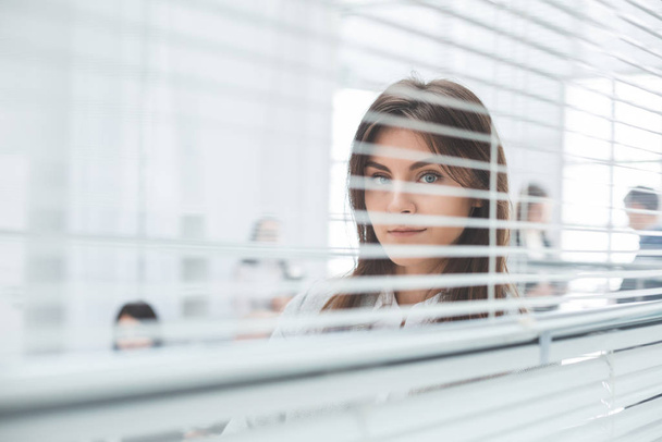 young business woman looking through office window - Foto, Imagem