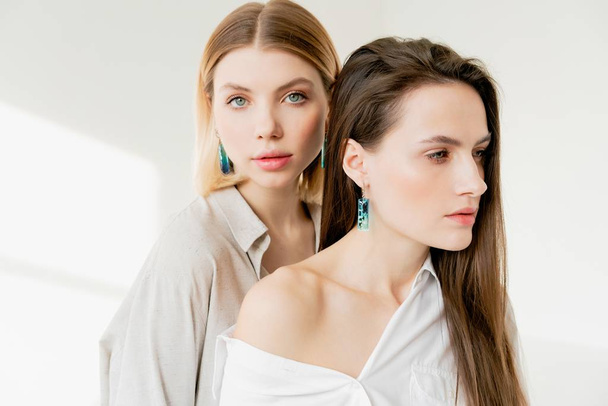 fashion portrait of two young pretty women in the studio - Fotografie, Obrázek