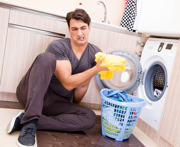Young husband man doing laundry at home - Fotografie, Obrázek