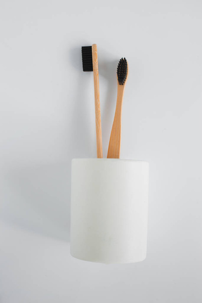 Natural eco bamboo toothbrush in stand on white background top view - Фото, изображение