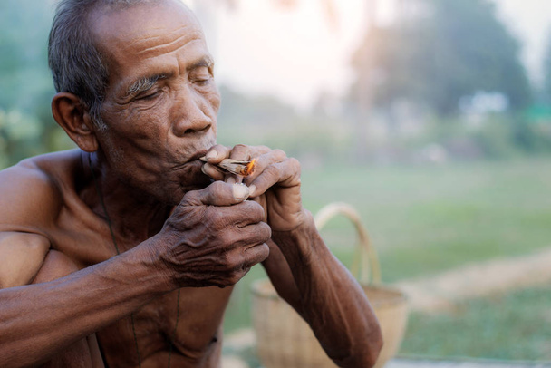 Old men are smoking cigarettes. - Photo, Image