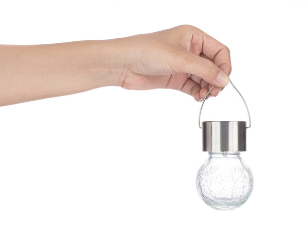 Hand holding glass ball lamp isolated on white background - Foto, Imagem