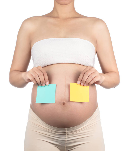 Μια γυναίκα έγκυος Εικάζοντας αγέννητο μωρό φύλο απομονώνονται σε λευκό β - Φωτογραφία, εικόνα
