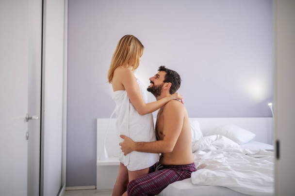 Young passionate couple cuddling in bedroom. - Valokuva, kuva