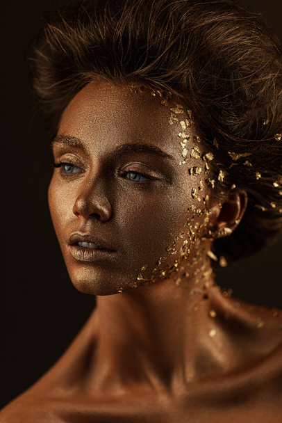 model girl with holiday golden shiny professional makeup. - Valokuva, kuva