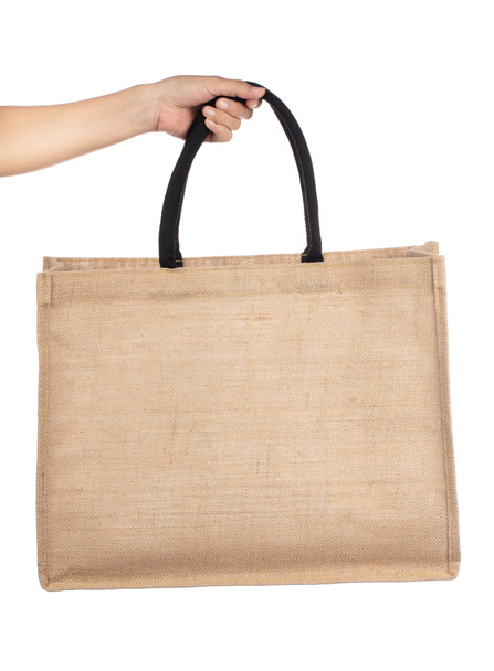 Рука тримає плечові сумки Модні конопляні сумки ізольовані на білому б
 - Фото, зображення