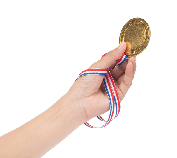 Siegerhand erhoben und Goldmedaille mit Schleifenisol in der Hand - Foto, Bild