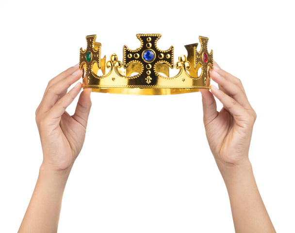 Hand holding crown golden isolated on a white background - Photo, Image