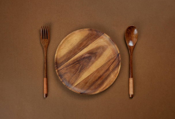 A wood plate on brown background - Фото, зображення