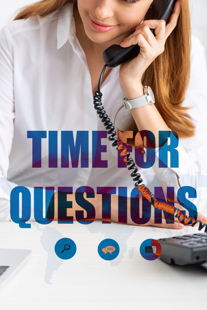 Cropped view of smiling businesswoman talking on telephone near laptop on table, time for questions illustration - Photo, Image