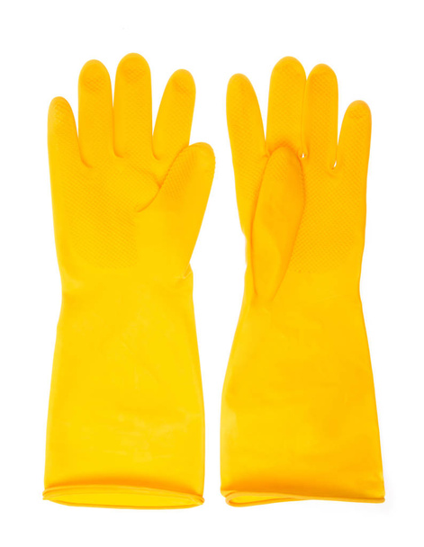 Gele plastic handschoenen geïsoleerd op witte achtergrond - Foto, afbeelding