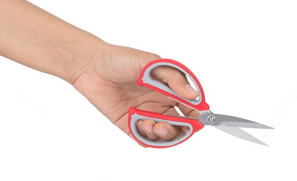 Ruka držící červené nůžky izolovaných na bílém pozadí. - Fotografie, Obrázek