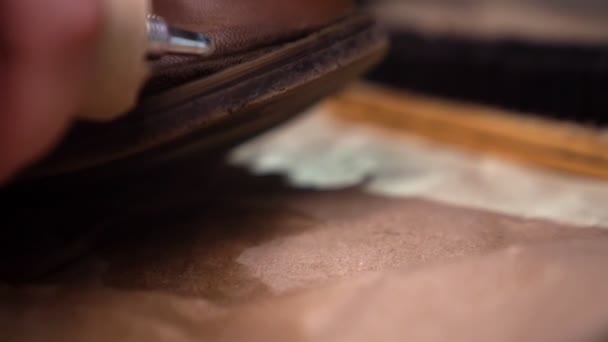 Shoe repair - put the glue on the sole. Close-up. - Video, Çekim
